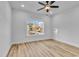 Bedroom with wood floors, overhead fan, and lots of light from the large window at 33 Captains Pl, Murrells Inlet, SC 29576