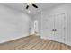 Large bedroom featuring wood-look floors, white walls, white trim, a ceiling fan, and neutral doors at 33 Captains Pl, Murrells Inlet, SC 29576