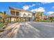 View of the house's exterior with a spacious concrete garage, a balcony, and stairs leading up at 33 Captains Pl, Murrells Inlet, SC 29576