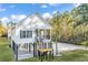 Stunning elevated coastal home with black shutters, stairs, and meticulously landscaped yard at 33 Captains Pl, Murrells Inlet, SC 29576