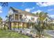Charming elevated home featuring a covered porch, sleek black railings, and well-maintained landscaping at 33 Captains Pl, Murrells Inlet, SC 29576