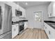 Modern kitchen with stainless steel appliances, white cabinets, and sleek black countertops at 33 Captains Pl, Murrells Inlet, SC 29576