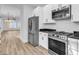 Modern kitchen featuring stainless steel appliances and granite countertops overlooking living area at 33 Captains Pl, Murrells Inlet, SC 29576