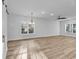 Light-filled living area with ample windows, wood floors, and modern ceiling fan at 33 Captains Pl, Murrells Inlet, SC 29576