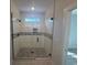 Close up of the stylish glass-enclosed shower with tiled walls, inset and decorative mosaic at 33 Captains Pl, Murrells Inlet, SC 29576