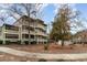 Tan multi-story building with balconies, surrounded by trees and landscaping at 415 Ocean Creek Dr. # 2280, Myrtle Beach, SC 29572