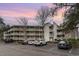 Condo building exterior with parking and landscaping at 415 Ocean Creek Dr. # 2280, Myrtle Beach, SC 29572