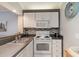 Clean and efficient kitchen with white cabinets and appliances at 415 Ocean Creek Dr. # 2280, Myrtle Beach, SC 29572