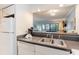 Kitchen with double sink, dishwasher, and view to living room at 415 Ocean Creek Dr. # 2280, Myrtle Beach, SC 29572