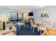 Open living and dining area with blue walls and balcony access at 415 Ocean Creek Dr. # 2280, Myrtle Beach, SC 29572