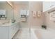 Elegant bathroom with double vanity, bathtub, and updated fixtures at 448 Colonial Trace Dr. # 448, Longs, SC 29568