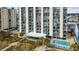 Aerial view of beachfront high-rise building with pool and ocean access at 4619 S Ocean Blvd. # 207, North Myrtle Beach, SC 29582