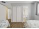 Bedroom with twin beds, white closet, and bathroom access at 4619 S Ocean Blvd. # 207, North Myrtle Beach, SC 29582
