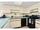 Full kitchen with black appliances and light cabinets at 4619 S Ocean Blvd. # 207, North Myrtle Beach, SC 29582