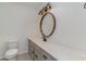 Clean bathroom with updated vanity and large circular mirror at 501 44Th Ave. N # D-3, Myrtle Beach, SC 29577