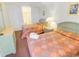 Bright bedroom featuring two beds with colorful linens and a light wood dresser at 507 S Ocean Blvd. # 201, North Myrtle Beach, SC 29582