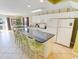 Spacious kitchen featuring a long breakfast bar and white cabinets, with a view of the dining area at 507 S Ocean Blvd. # 201, North Myrtle Beach, SC 29582