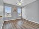 Charming bedroom with gray walls, wood-look floors, and two bright windows at 5096 Capulet Circle, Myrtle Beach, SC 29588