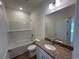 Bathroom featuring a granite-topped vanity, a large mirror, and a shower-tub combination with tiled surround at 541 Honeyhill Loop, Conway, SC 29526