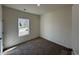 Cozy bedroom with plush carpeting, a large window providing natural light, and neutral wall colors at 541 Honeyhill Loop, Conway, SC 29526