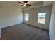 Spacious bedroom with tray ceiling and ceiling fan features two windows allowing for natural light at 541 Honeyhill Loop, Conway, SC 29526