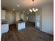 Open-concept kitchen and dining area featuring granite countertops, a breakfast bar, and modern lighting at 541 Honeyhill Loop, Conway, SC 29526