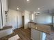 Well-lit kitchen with granite countertops, a kitchen island with a sink, and ample storage space at 541 Honeyhill Loop, Conway, SC 29526