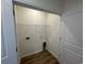 Convenient laundry room with shelving and hookups, with wood-look flooring, located inside the home at 541 Honeyhill Loop, Conway, SC 29526