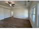 Spacious living room with tray ceiling and ceiling fan, offering abundant natural light from large windows at 541 Honeyhill Loop, Conway, SC 29526