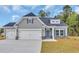 Charming single-Gathering home features gray siding, stone accents, and a two-car garage at 556 Honeyhill Loop, Conway, SC 29526
