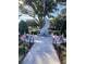 Veterans memorial featuring an engraved stone monument, flags, and landscaped pathway in a serene setting at 556 Honeyhill Loop, Conway, SC 29526