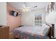 Bedroom with floral comforter, dresser, and pink accent wall at 6001 - 1563 S Kings Hwy., Myrtle Beach, SC 29575