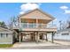 Two-story beach house with elevated foundation, deck, and parking underneath at 6001 - 1563 S Kings Hwy., Myrtle Beach, SC 29575