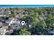 Aerial view of the neighborhood, nestled among lush trees, with the ocean visible in the distance at 6001 South Kings Hwy., Myrtle Beach, SC 29575