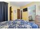 Comfortable bedroom featuring yellow walls, TV and doors to other rooms at 6001 South Kings Hwy., Myrtle Beach, SC 29575