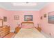 Charming bedroom with pink walls, wicker headboard, and coastal-themed art at 6001-1340 S Kings Hwy., Myrtle Beach, SC 29575