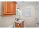 Small bathroom with granite countertop, wood cabinets, and window with blinds at 6001-1909 S Kings Hwy., Myrtle Beach, SC 29575