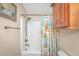 Bathroom with shower, wood cabinets, and beach-themed shower curtain at 6001-1909 S Kings Hwy., Myrtle Beach, SC 29575