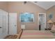 Primary bedroom with large picture window, walk-in closet, and wood flooring at 6001-1909 S Kings Hwy., Myrtle Beach, SC 29575
