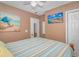Bright bedroom with a double bed, wall-mounted TV, and beach decor at 6001-1909 S Kings Hwy., Myrtle Beach, SC 29575