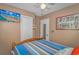 Bedroom with wood-framed bed, TV, and beach-themed decor at 6001-1909 S Kings Hwy., Myrtle Beach, SC 29575