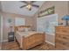 Bedroom with wood bed frame, window with blinds, and ceiling fan at 6001-1909 S Kings Hwy., Myrtle Beach, SC 29575