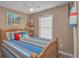 Bedroom with wood-framed bed, beach decor, and window with blinds at 6001-1909 S Kings Hwy., Myrtle Beach, SC 29575