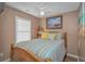 Bedroom with wood bed frame, window with blinds, and beach-themed decor at 6001-1909 S Kings Hwy., Myrtle Beach, SC 29575