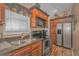 Well-equipped kitchen with stainless steel appliances and wood cabinets at 6001-1909 S Kings Hwy., Myrtle Beach, SC 29575
