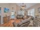 Living room with hardwood floors, comfortable seating, and access to deck at 6001-1909 S Kings Hwy., Myrtle Beach, SC 29575