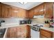 Galley kitchen with wood cabinets and modern appliances at 6001-5732 S Kings Hwy., Myrtle Beach, SC 29575