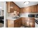 Galley kitchen with wood cabinets and modern appliances at 6001-5732 S Kings Hwy., Myrtle Beach, SC 29575