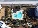 Aerial view of a community pool complex near the beach with lots of trees and grass around the complex at 645 Retreat Beach Circle, Pawleys Island, SC 29585