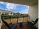 Relax on the balcony with chairs and enjoy views of the pool, beach, and ocean beyond at 645 Retreat Beach Circle, Pawleys Island, SC 29585